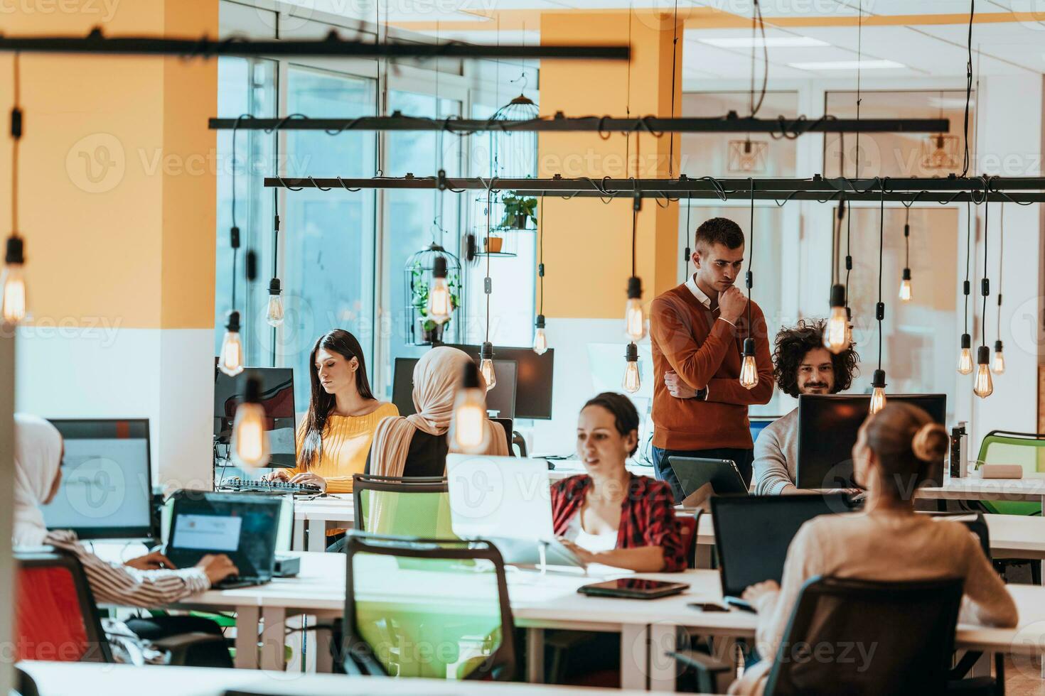 Multiethnic group of employees working in a marketing company. A group of colleagues is working on a project in modern offices photo