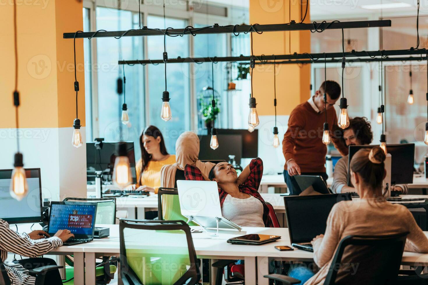 Multiethnic group of employees working in a marketing company. A group of colleagues is working on a project in modern offices photo