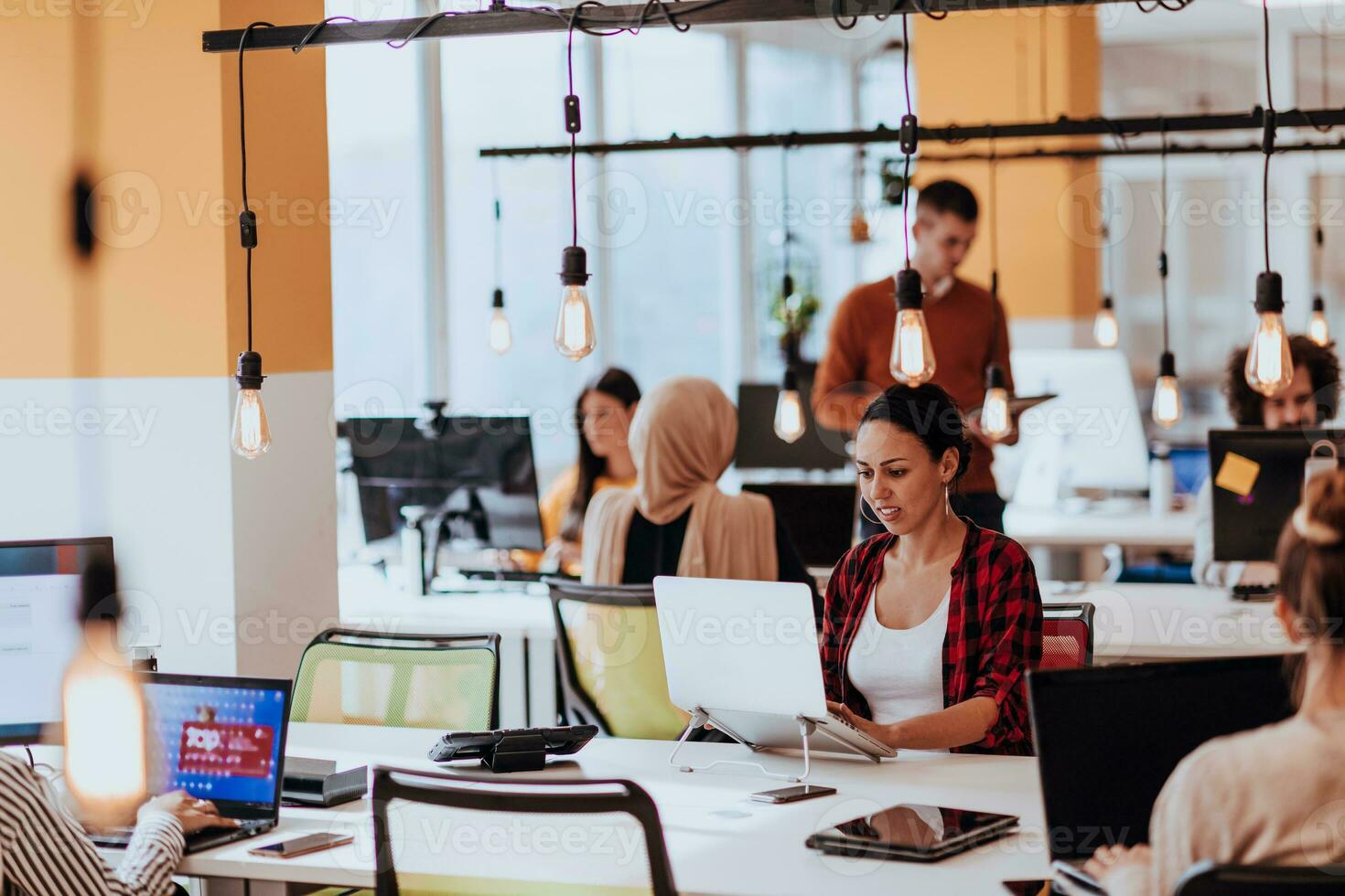 Multiethnic group of employees working in a marketing company. A group of colleagues is working on a project in modern offices photo