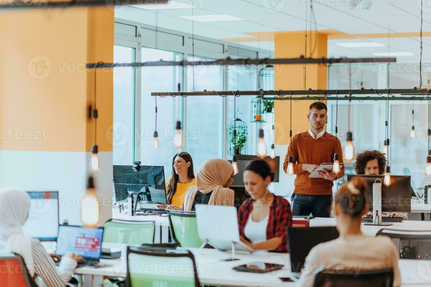 Multiethnic group of employees working in a marketing company. A group of colleagues is working on a project in modern offices photo