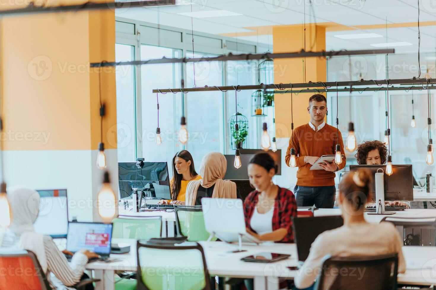 Multiethnic group of employees working in a marketing company. A group of colleagues is working on a project in modern offices photo