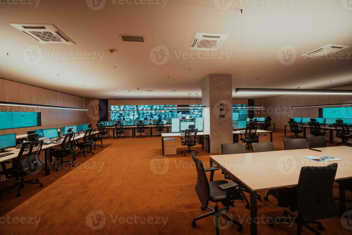 Empty interior of big modern security system control room, workstation with multiple displays, monitoring room with at security data center Empty office, desk, and chairs at a main CCTV security data photo