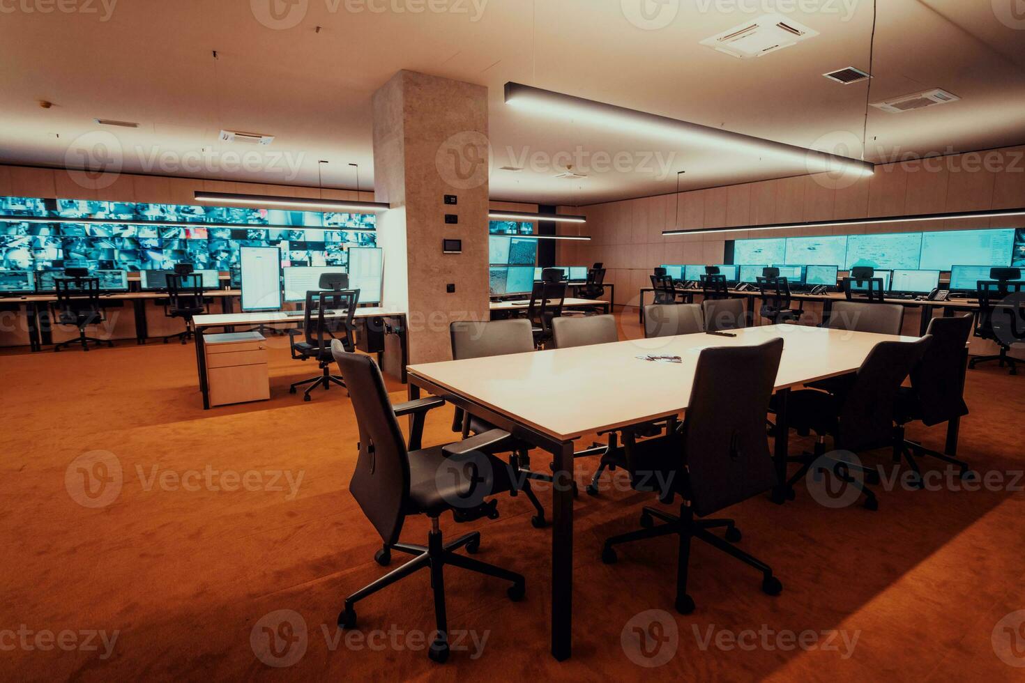 Empty interior of big modern security system control room, workstation with multiple displays, monitoring room with at security data center Empty office, desk, and chairs at a main CCTV security data photo