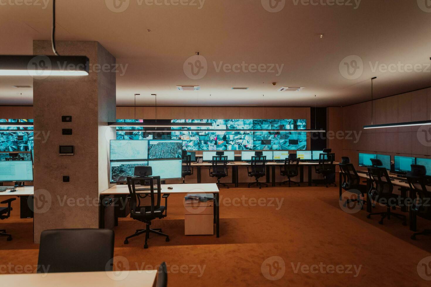 Empty interior of big modern security system control room, workstation with multiple displays, monitoring room with at security data center Empty office, desk, and chairs at a main CCTV security data photo