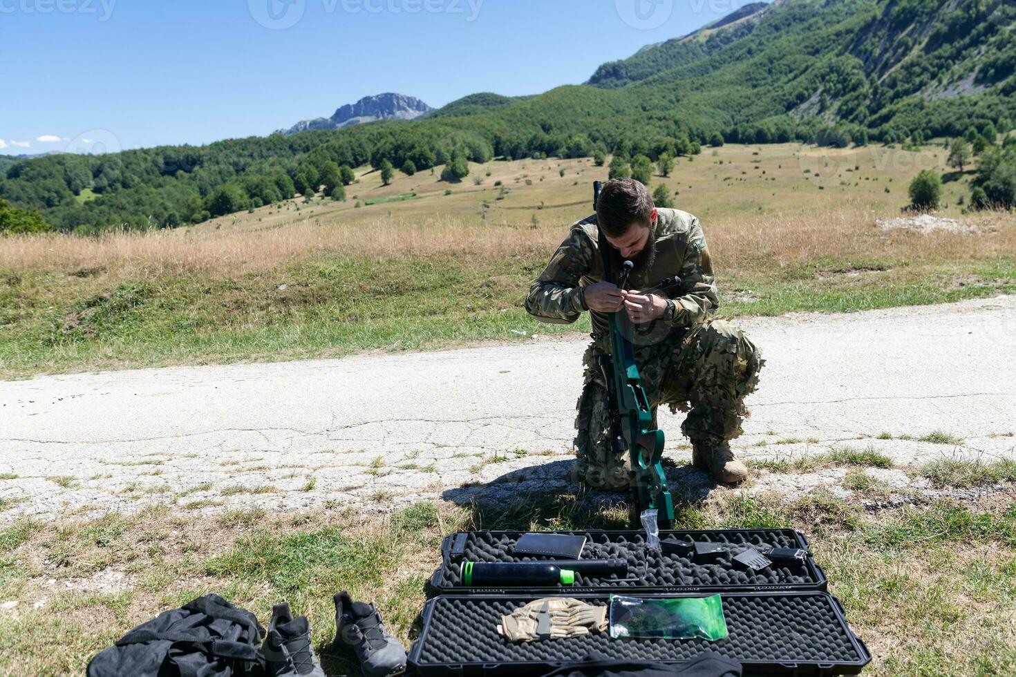 Special operations soldiers team preparing tactical and communication gear for action battle. Long distance sniper team in checking gear for action photo