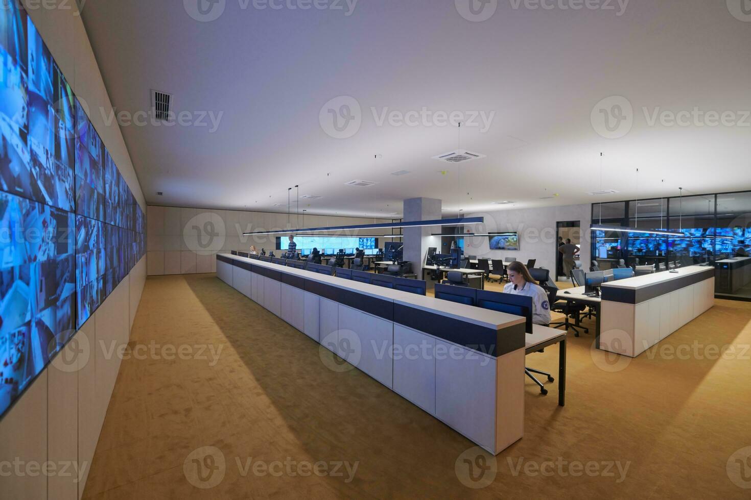 Female operator working in a security data system control room photo