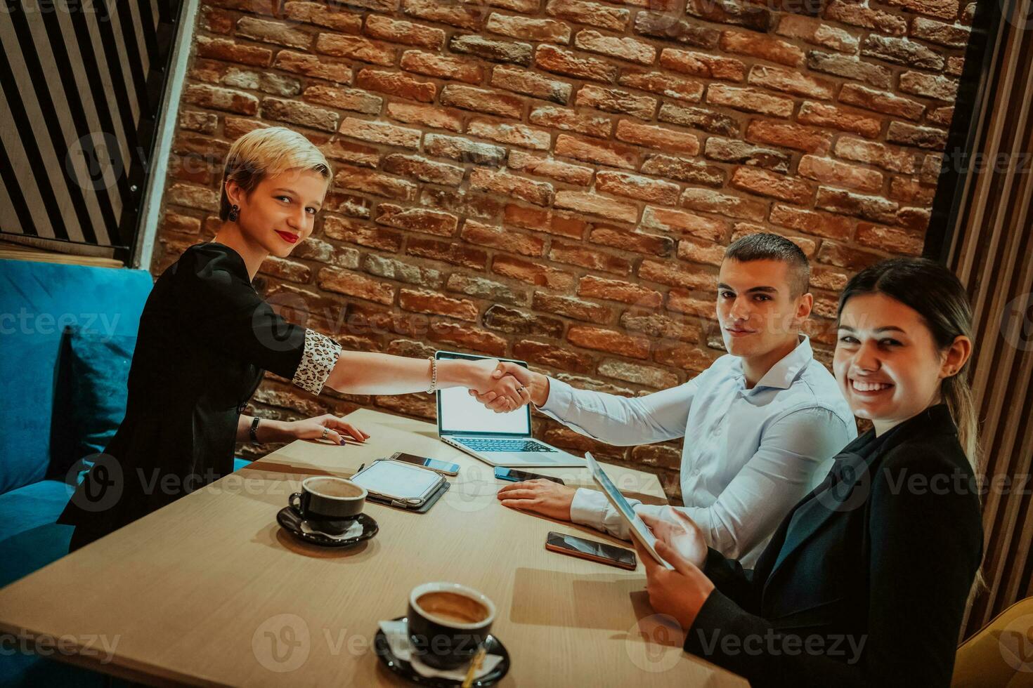 Business shaking hands, finishing up meeting. Successful businesspeople handshaking after good deal. photo