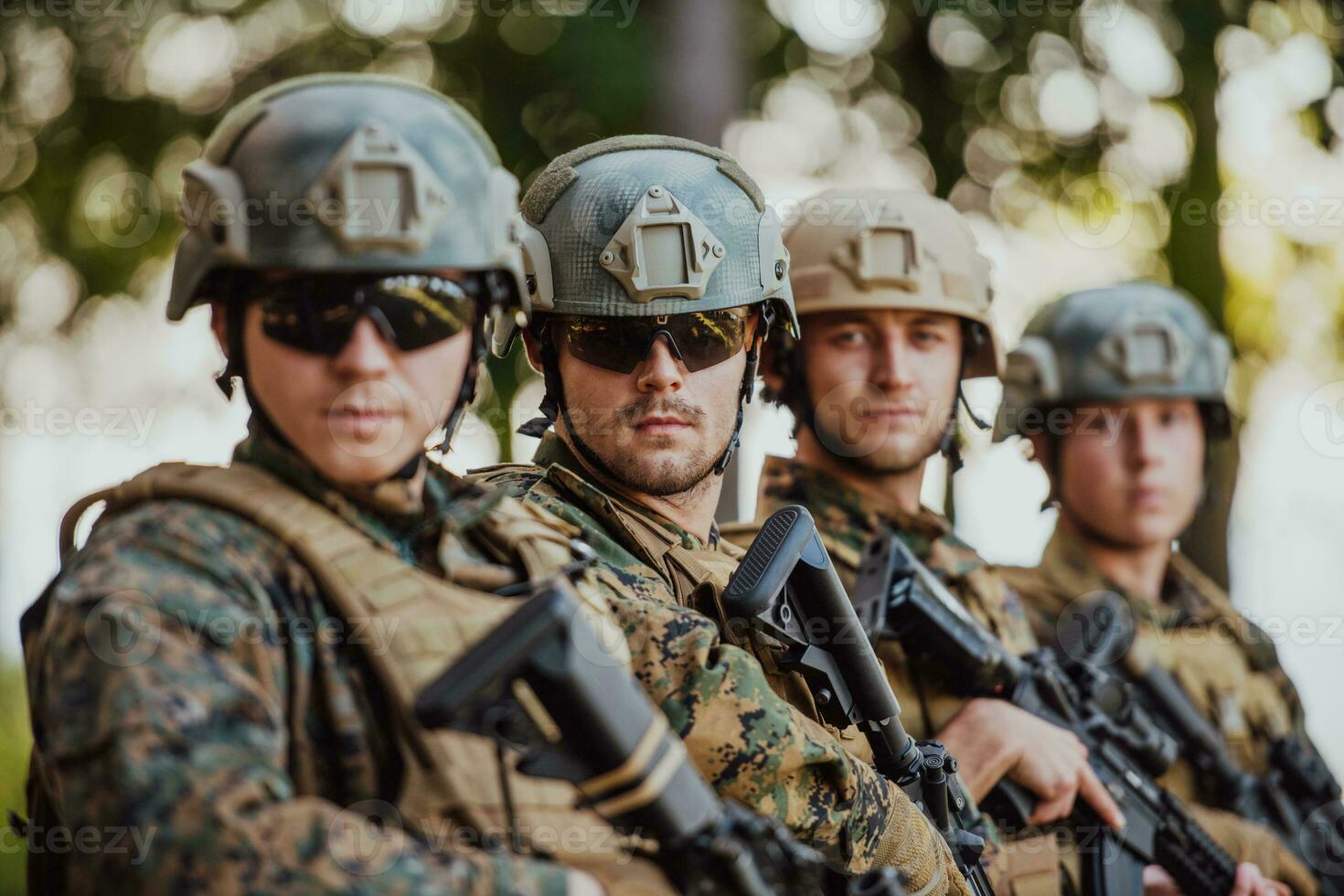 Soldier fighters standing together with guns. Group portrait of US army elite members, private military company servicemen, anti terrorist squad photo