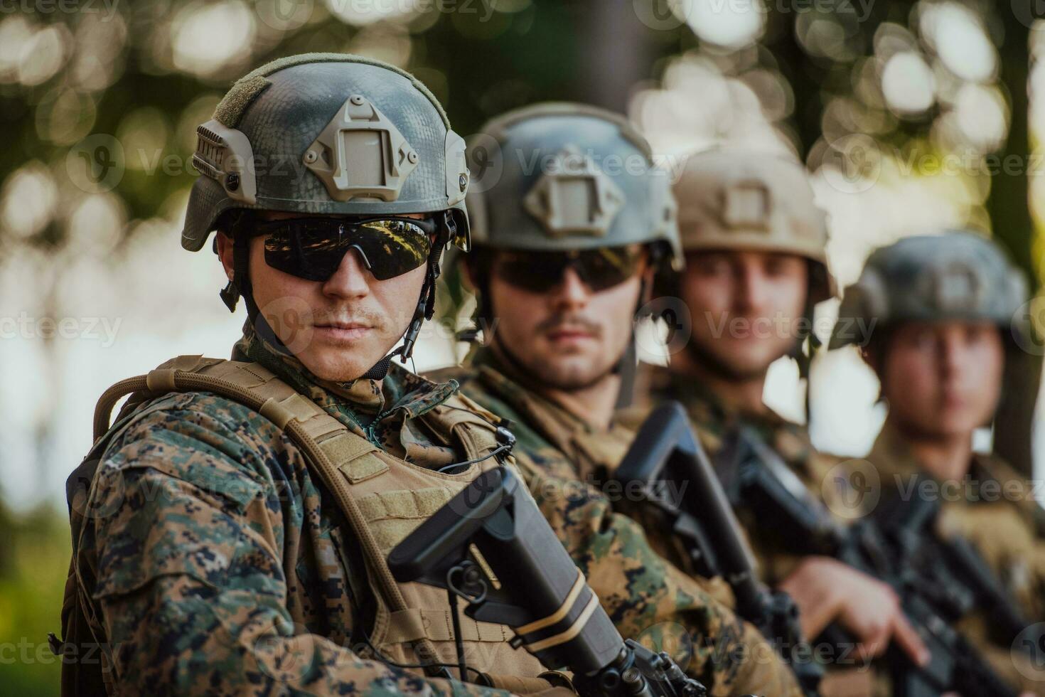 Soldier fighters standing together with guns. Group portrait of US army elite members, private military company servicemen, anti terrorist squad photo