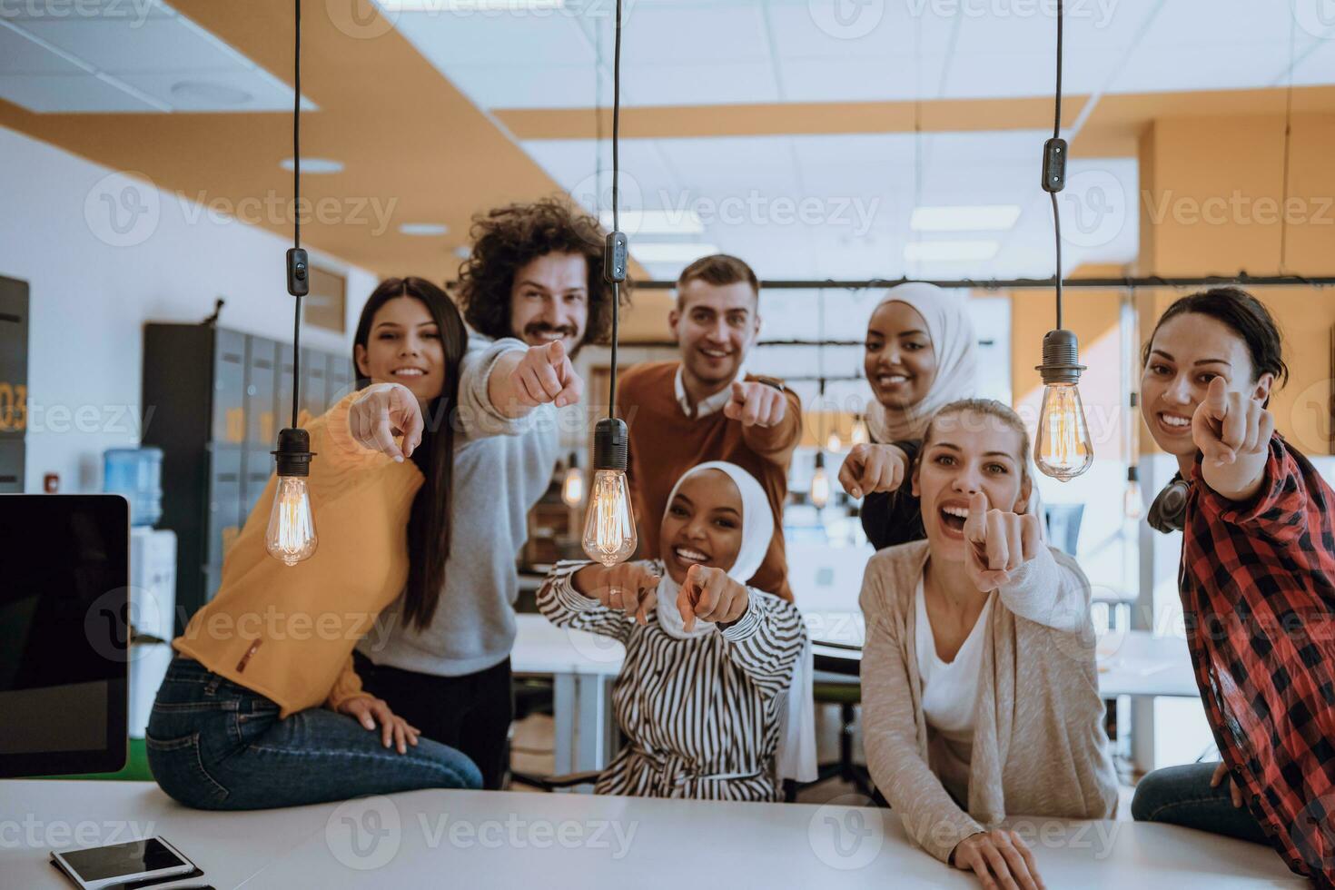 Multiethnic group of employees working in a marketing company. A group of colleagues is working on a project in modern offices photo