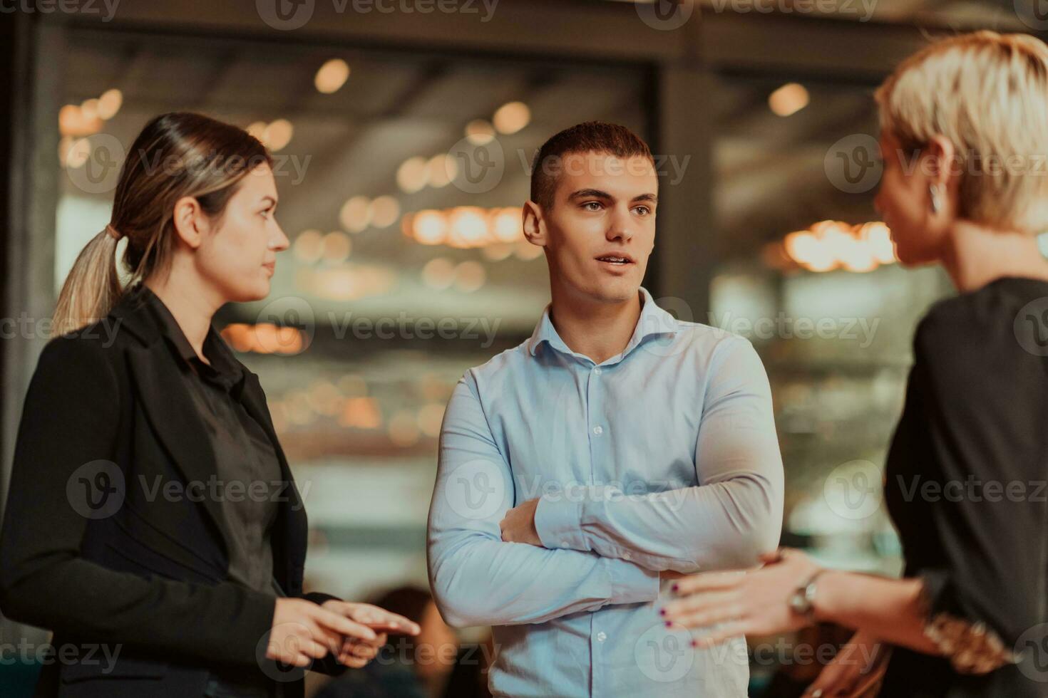 Photo of a business team of young people discussing business ideas in a modern urban environment. Selective focus