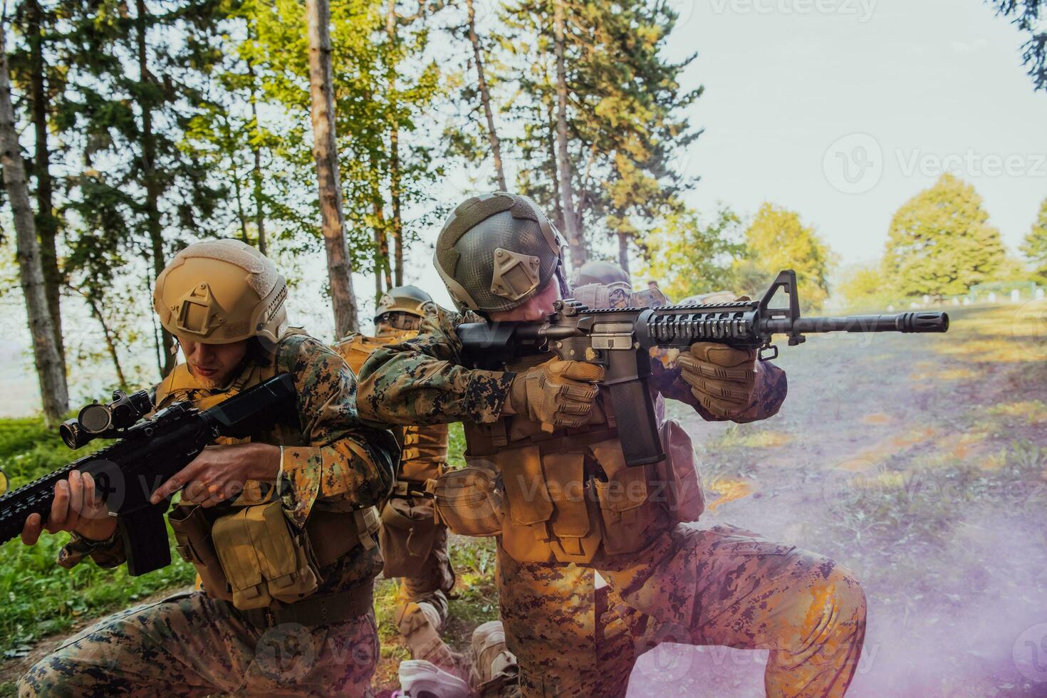A group of modern warfare soldiers is fighting a war in dangerous remote forest areas. A group of soldiers is fighting on the enemy line with modern weapons. The concept of warfare and military conflicts photo