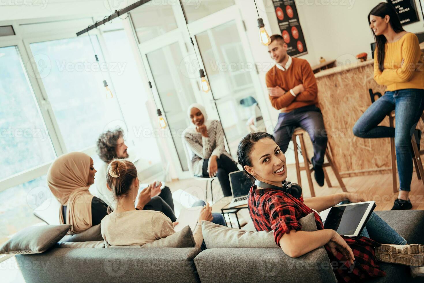 Young designer giving some new ideas about project to his partners in conference room. Business people discussing over new business project in office. photo