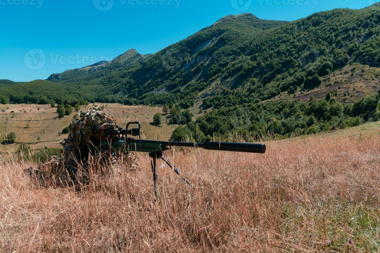 Army soldier holding sniper rifle with scope and aiming in forest. War, army, technology and people concept photo