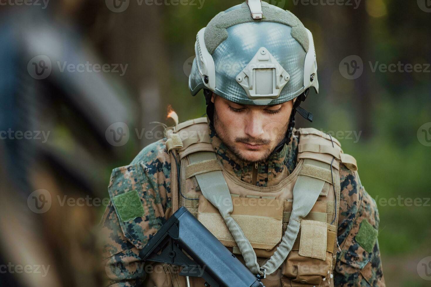 A modern warfare soldier on war duty in dense and dangerous forest areas. Dangerous military rescue operations photo