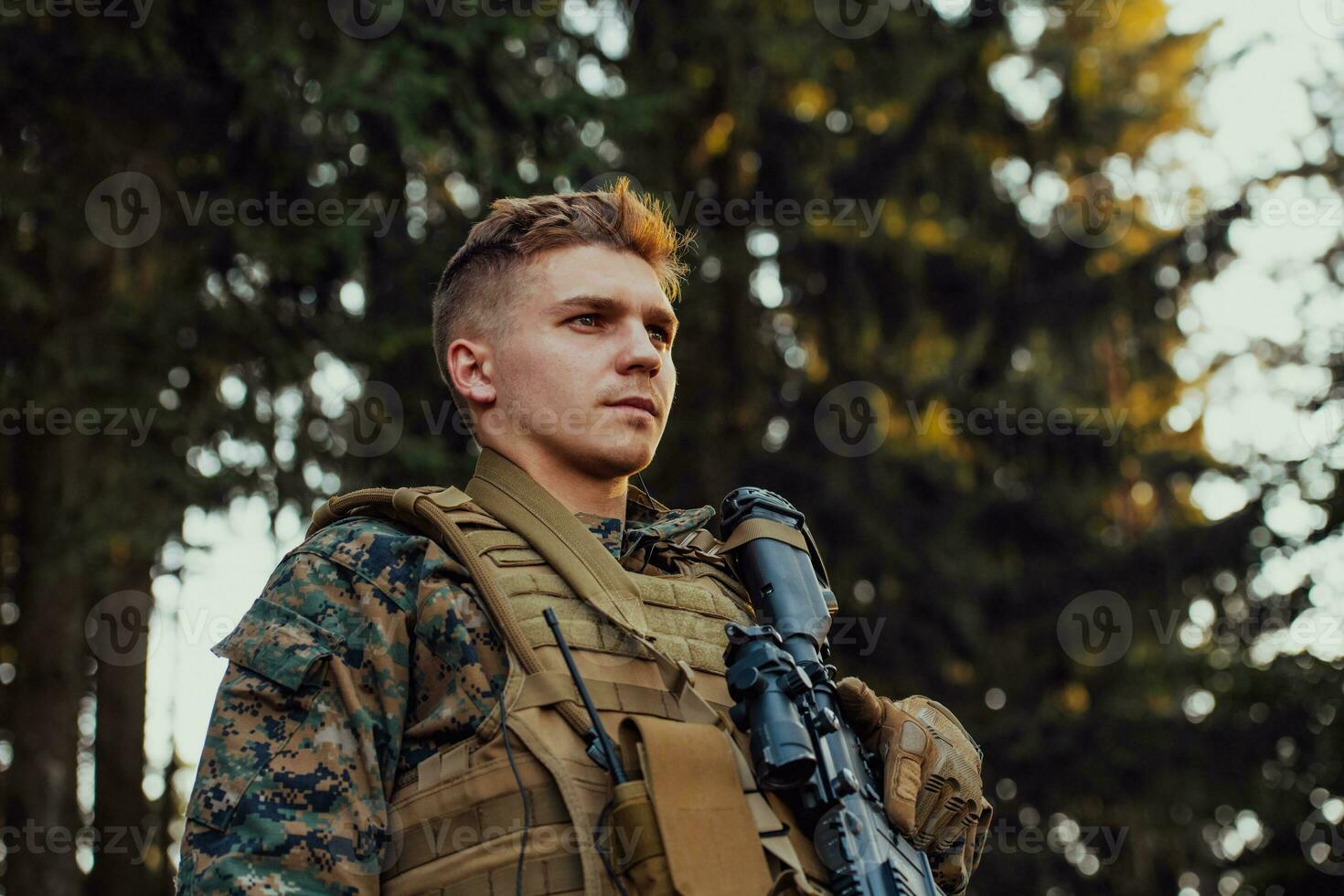 A modern warfare soldier on war duty in dense and dangerous forest areas. Dangerous military rescue operations photo