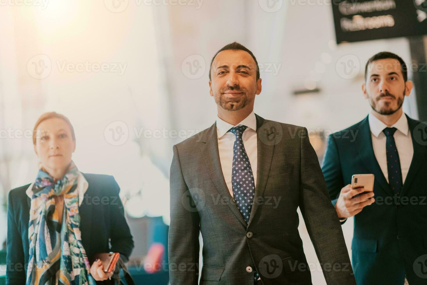 Photo of a business team in suits walking in a modern corporation. Successful business team. Selective focus