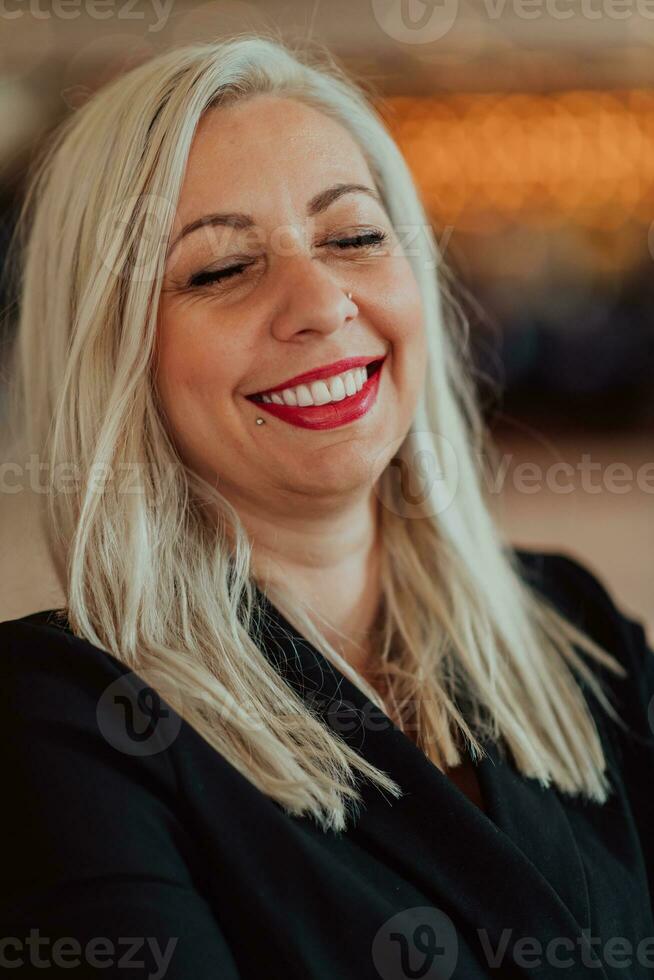 Portrait of business senior woman with crossed arms standing in modern corporation. Selective focus photo