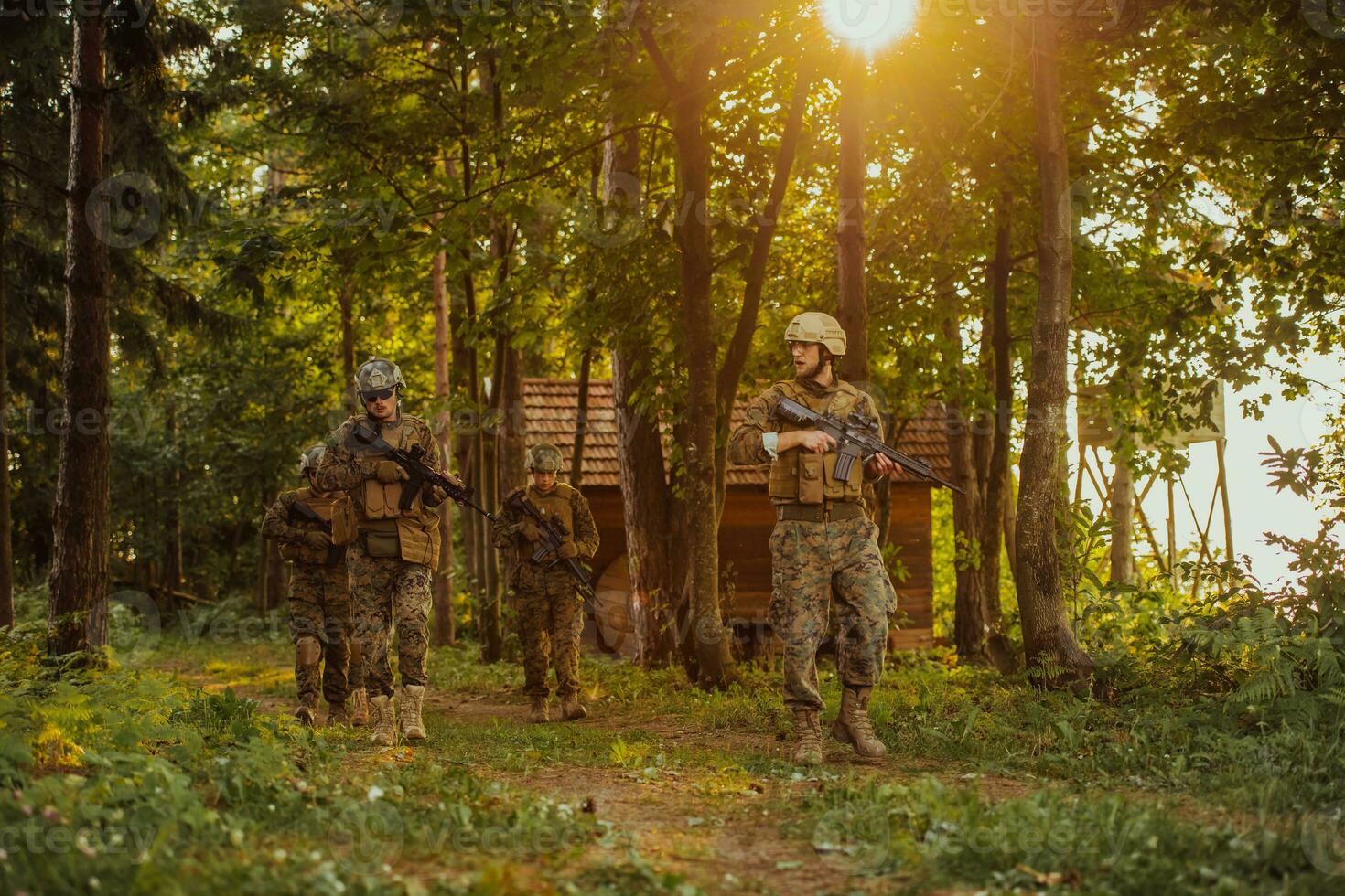 A group of modern warfare soldiers is fighting a war in dangerous remote forest areas. A group of soldiers is fighting on the enemy line with modern weapons. The concept of warfare and military conflicts photo
