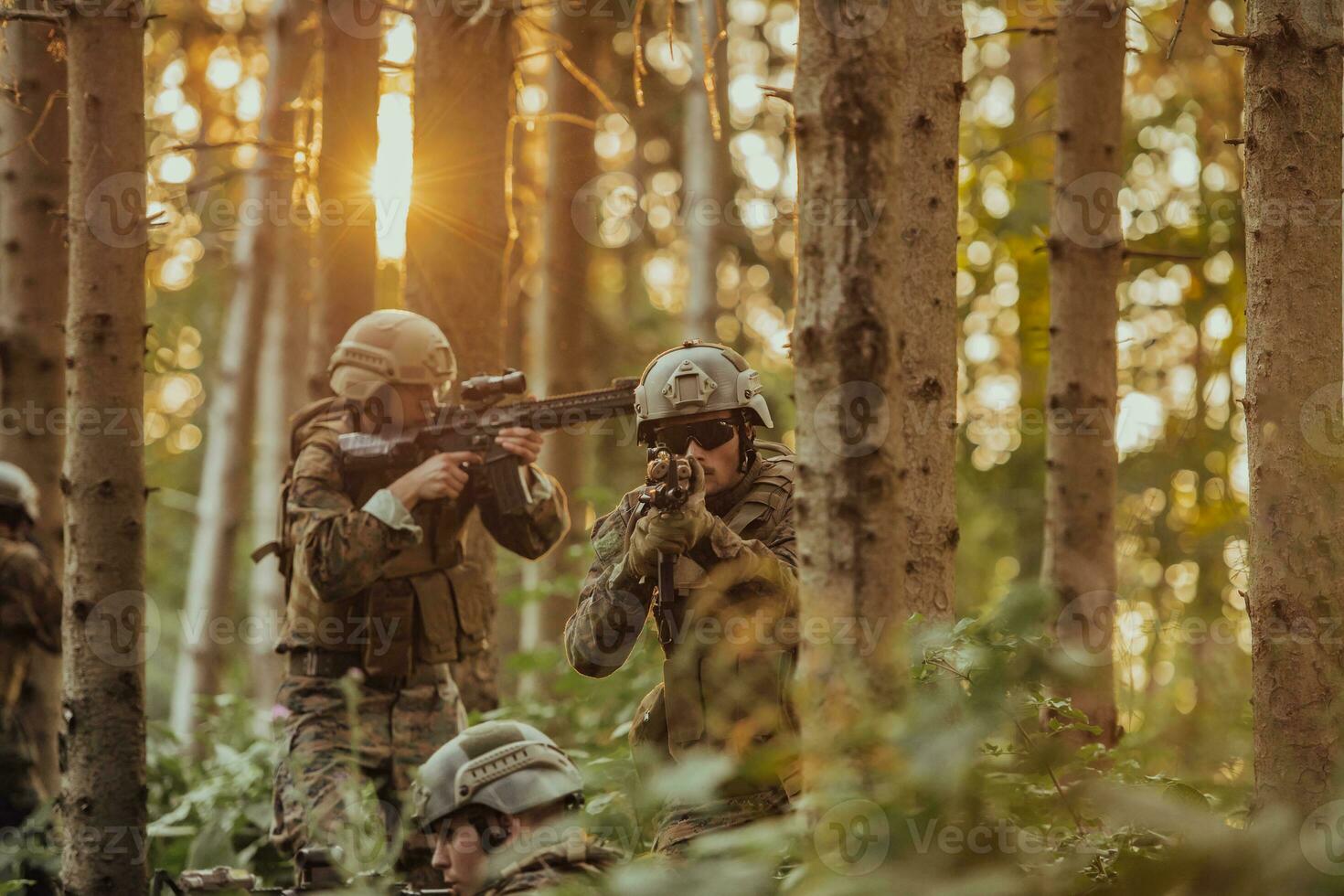 A group of modern warfare soldiers is fighting a war in dangerous remote forest areas. A group of soldiers is fighting on the enemy line with modern weapons. The concept of warfare and military conflicts photo