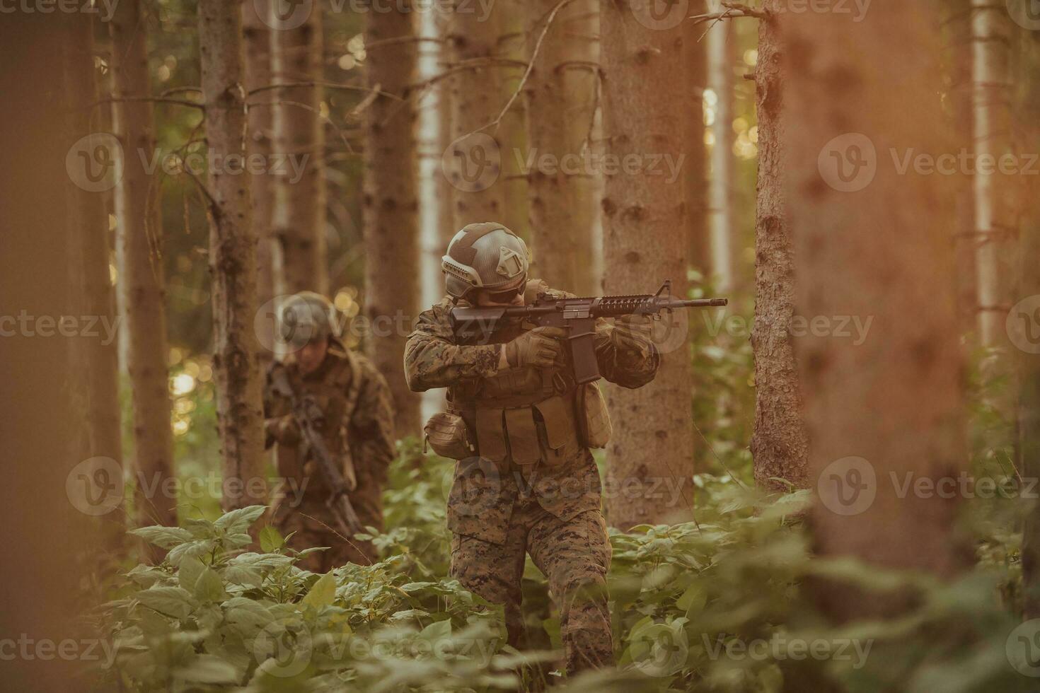 A group of modern warfare soldiers is fighting a war in dangerous remote forest areas. A group of soldiers is fighting on the enemy line with modern weapons. The concept of warfare and military conflicts photo