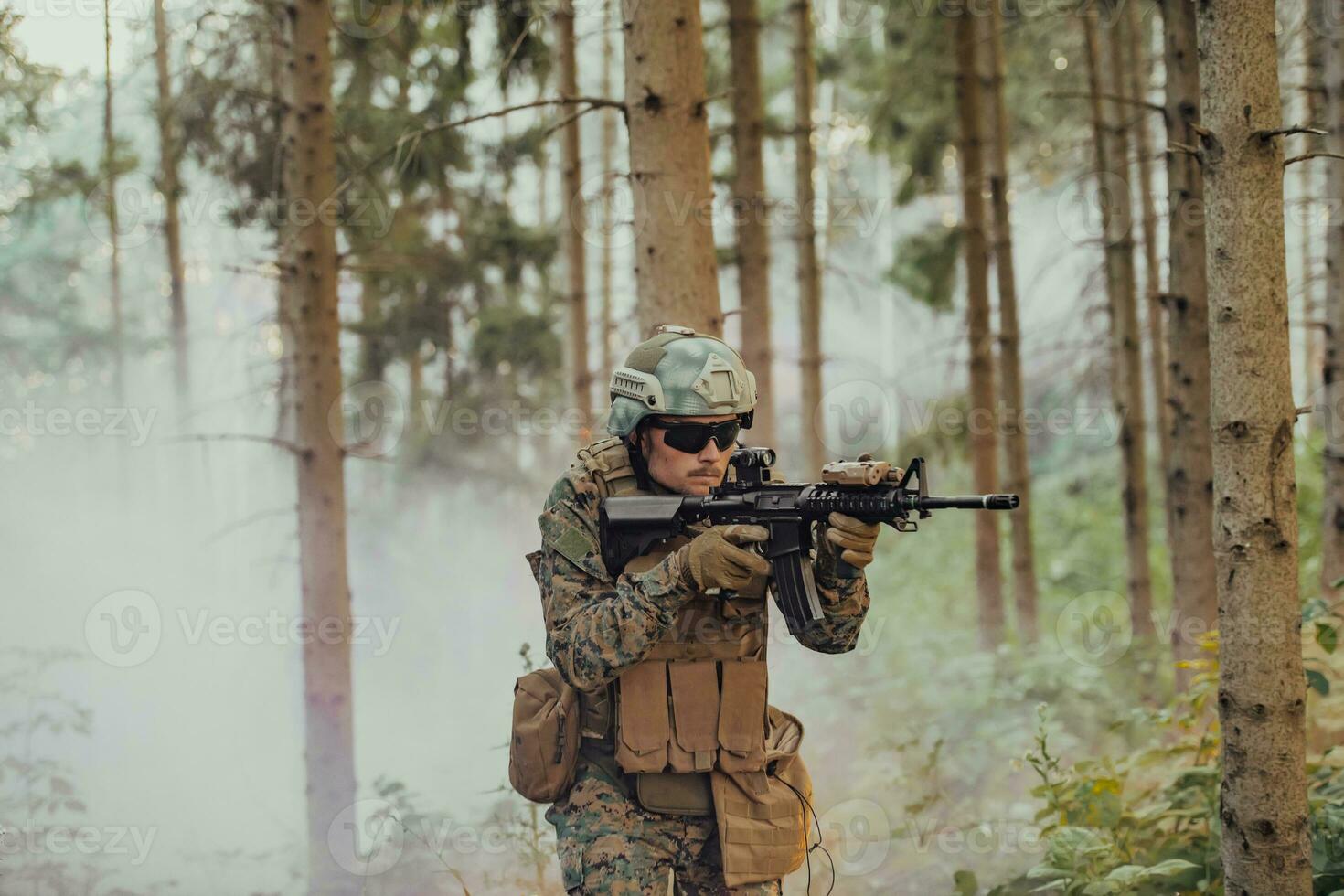 A modern warfare soldier on war duty in dense and dangerous forest areas. Dangerous military rescue operations photo