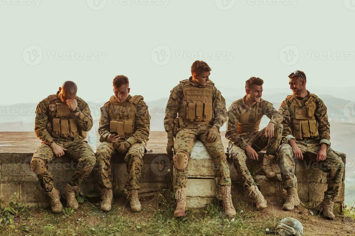 Soldiers squad relaxing after battle having a break on training photo