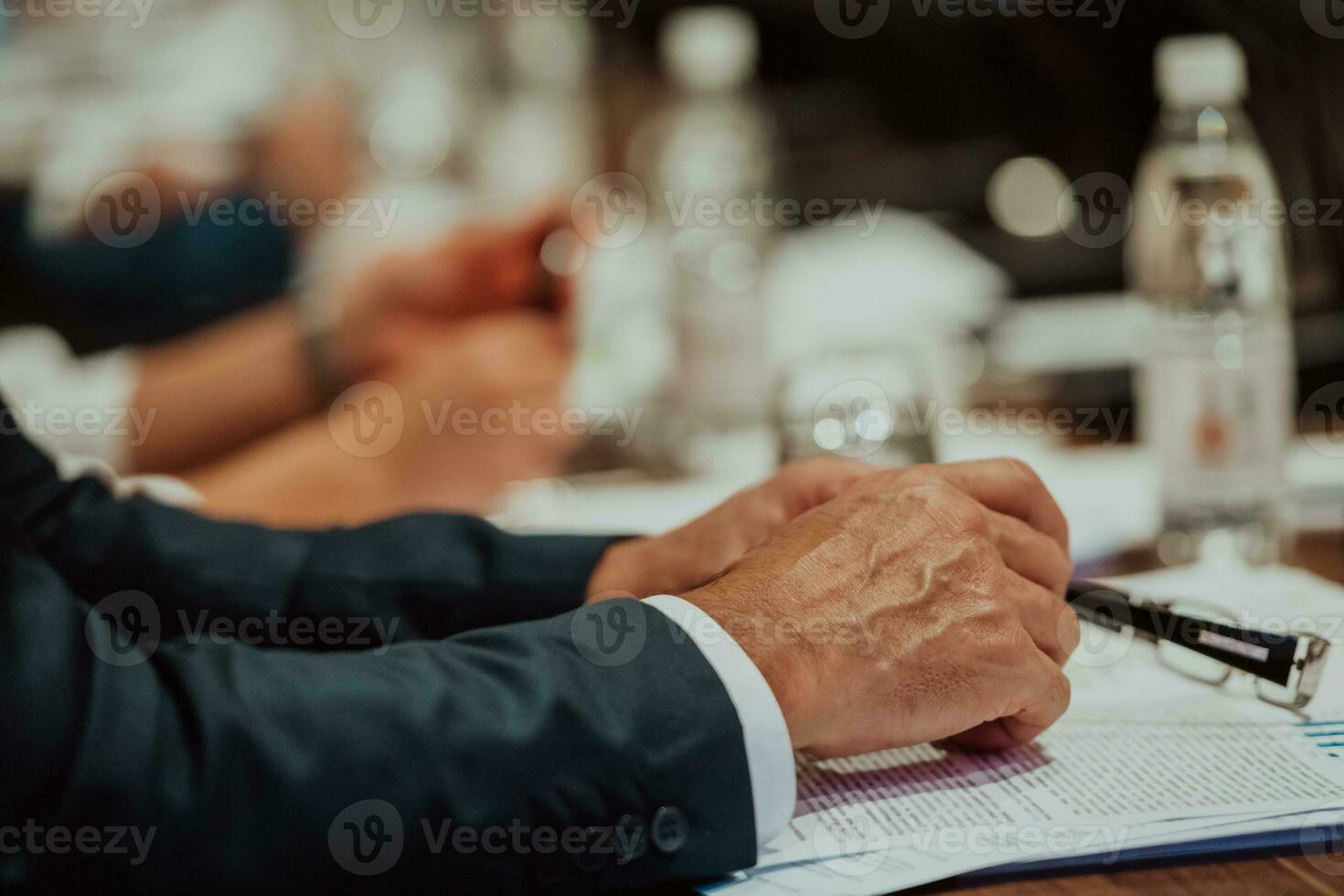 Close-up photo of businessmen who are at a meeting and business meeting in a modern hall