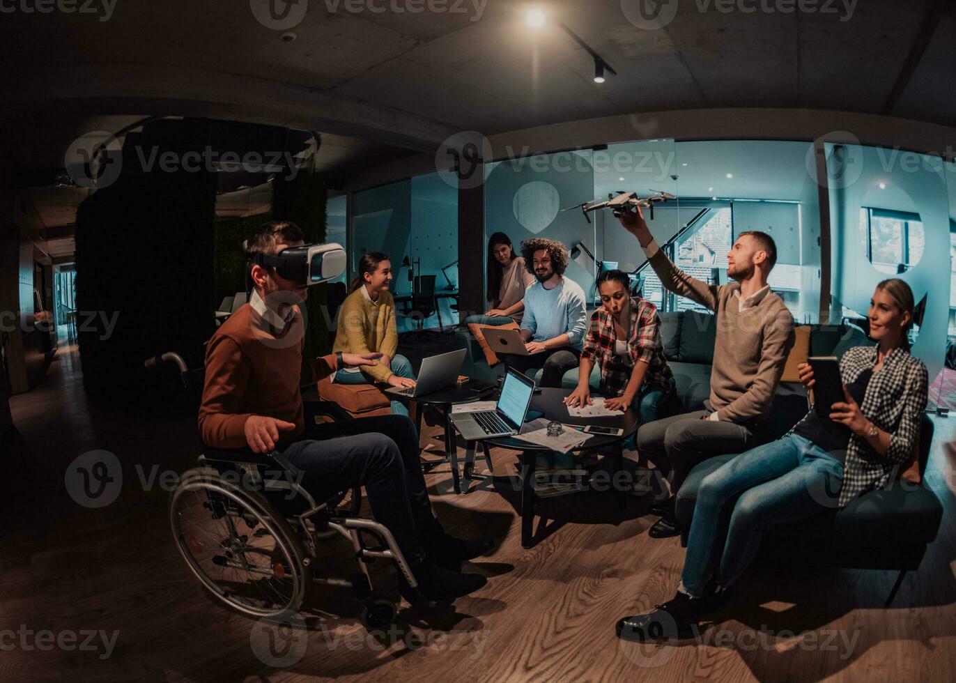 Business persons with a disability at work in modern open space coworking office on team meeting using virtual reality goggles. photo