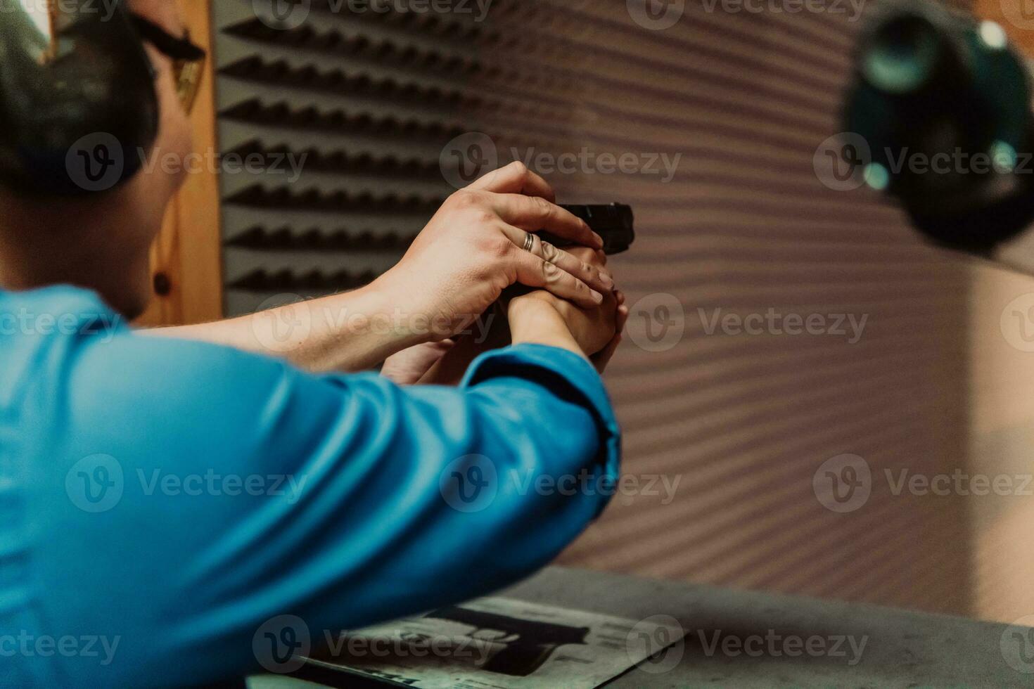 The trainer explaining to the man how to use the gun. Training in the shooting range photo