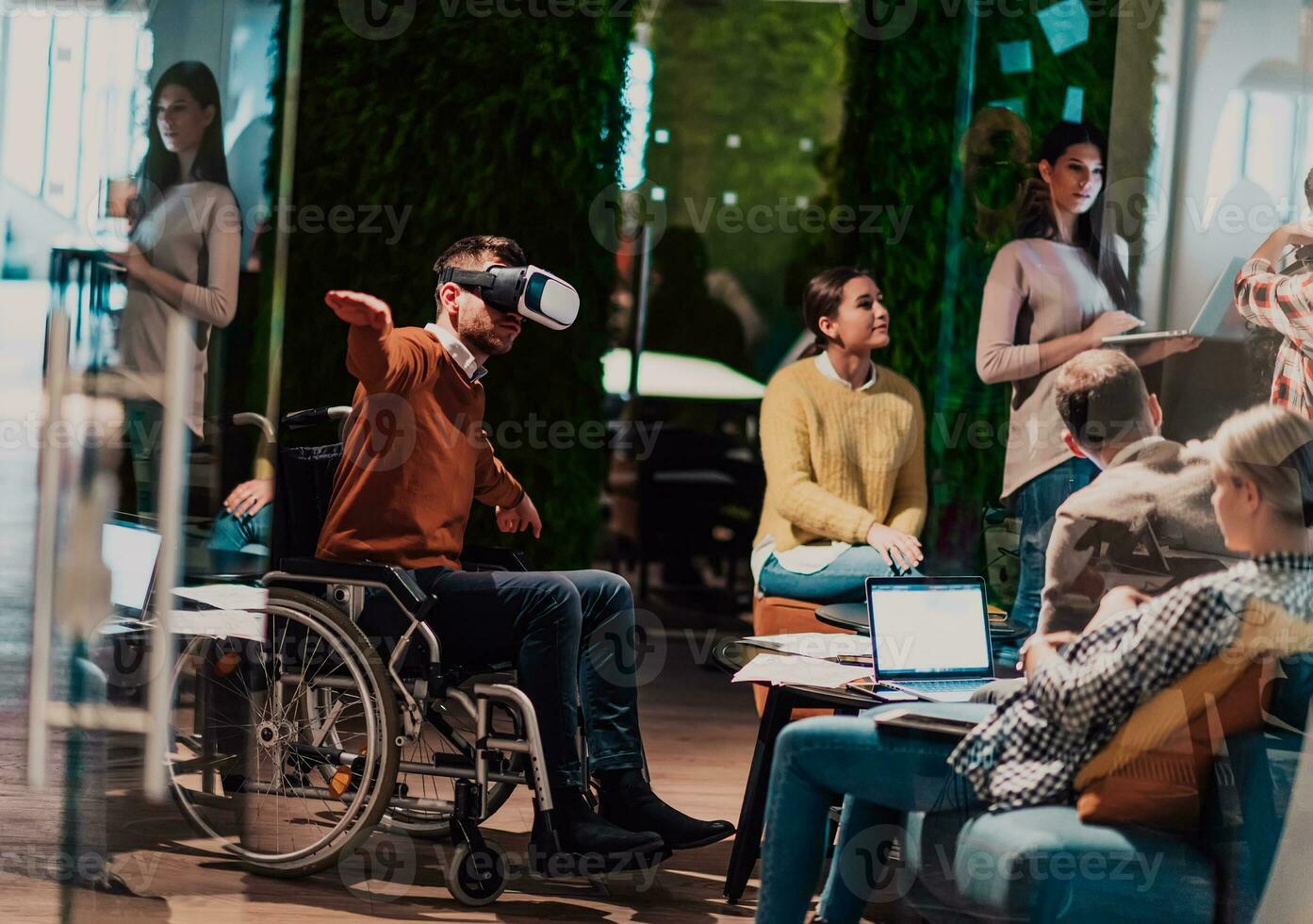 Business persons with a disability at work in modern open space coworking office on team meeting using virtual reality goggles. photo