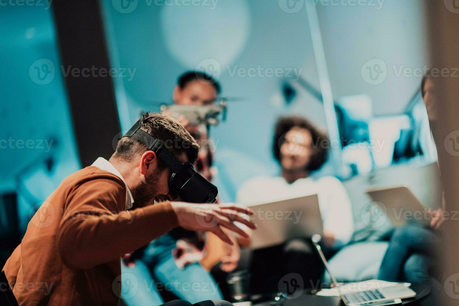 Business persons with a disability at work in modern open space coworking office on team meeting using virtual reality goggles. photo