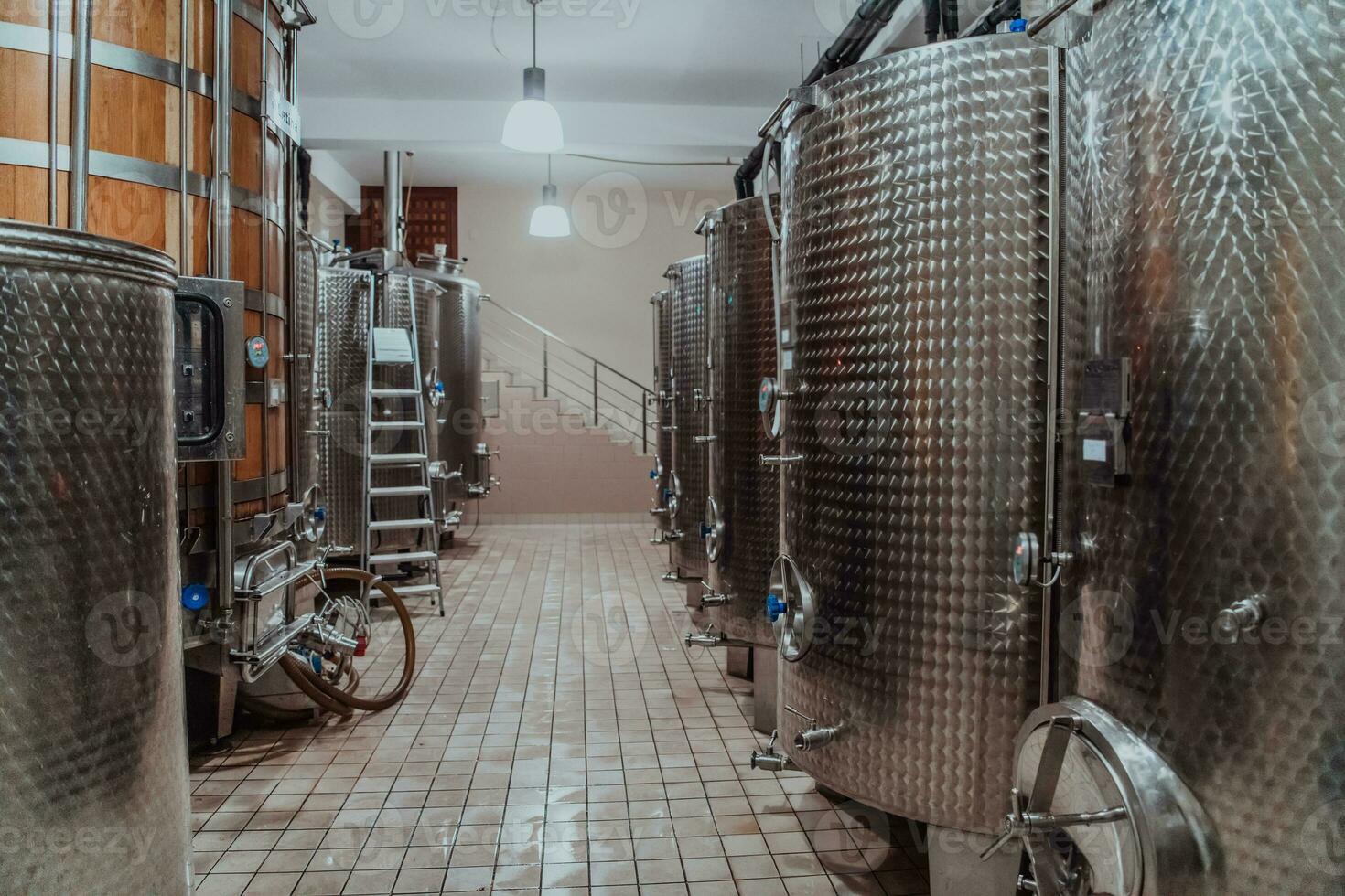 Modern wine distillery and brewery with brew kettles pipes and stainless steel tanks photo