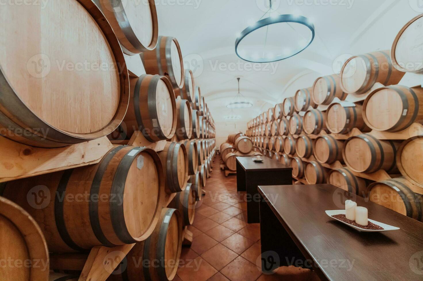 Wine or cognac barrels in the cellar of the winery, Wooden wine barrels in perspective. Wine vaults.Vintage oak barrels of craft beer or brandy. photo