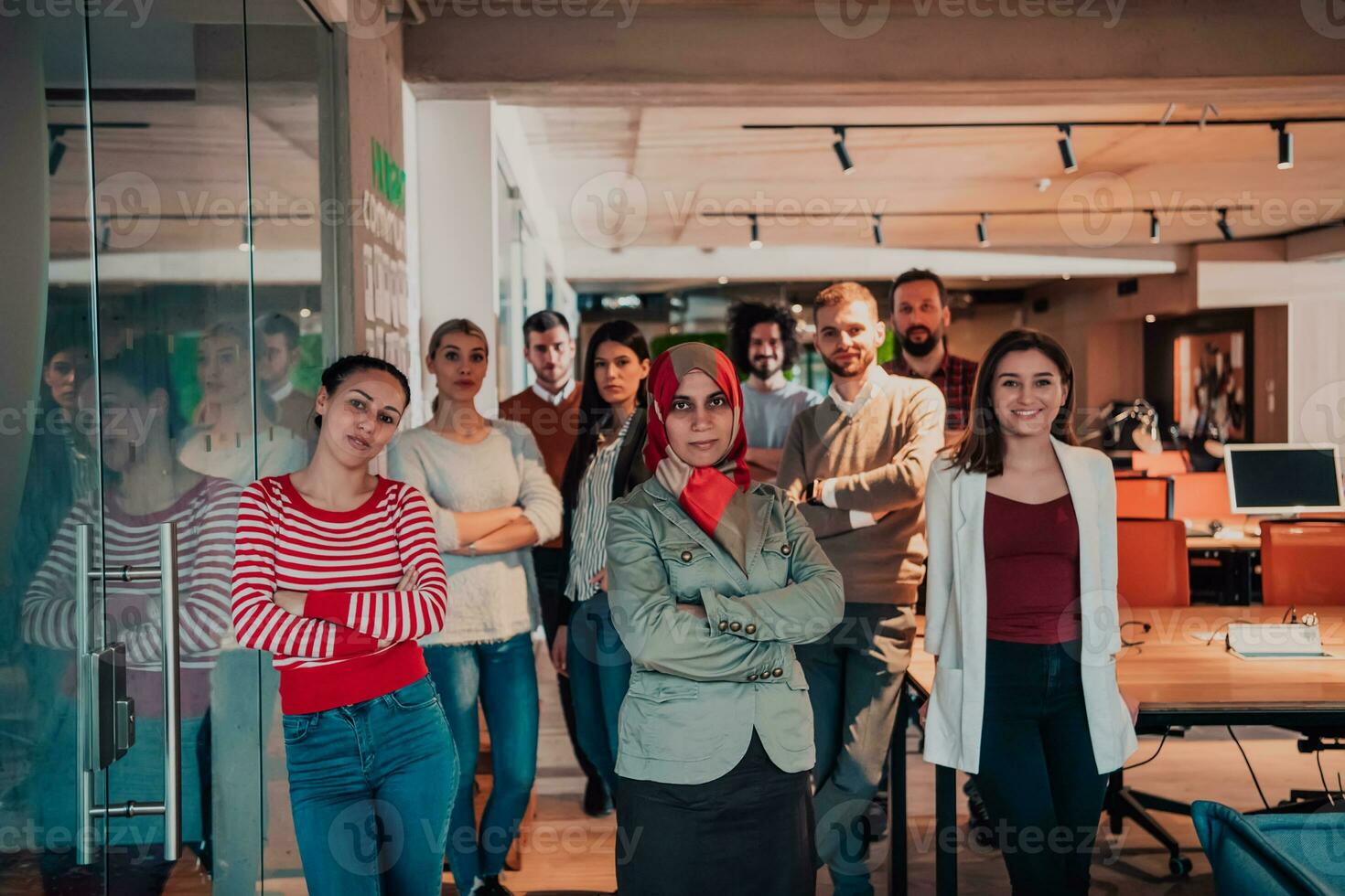 A diverse group of successful business people in a modern glass office. photo