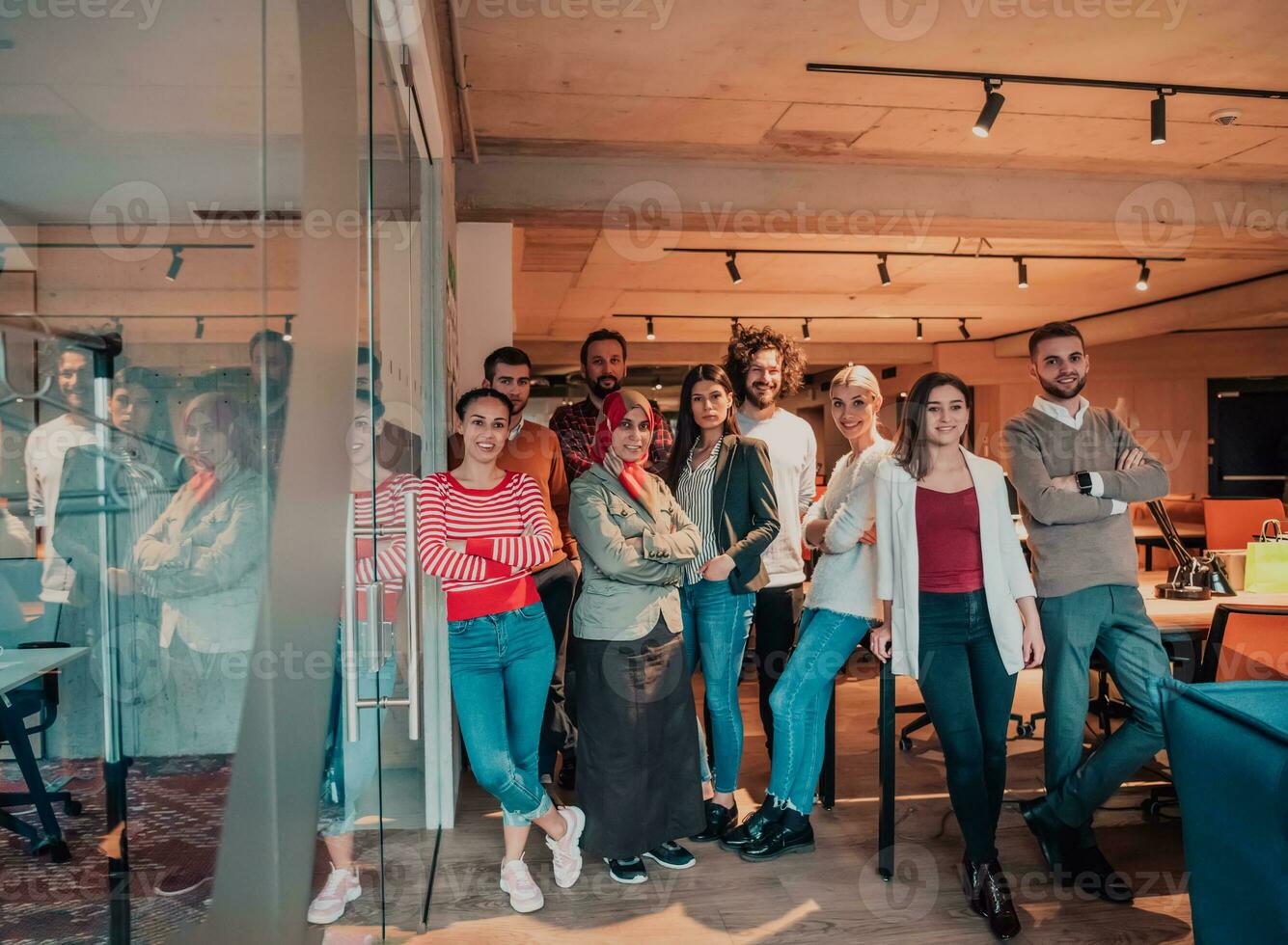 A diverse group of successful business people in a modern glass office. photo