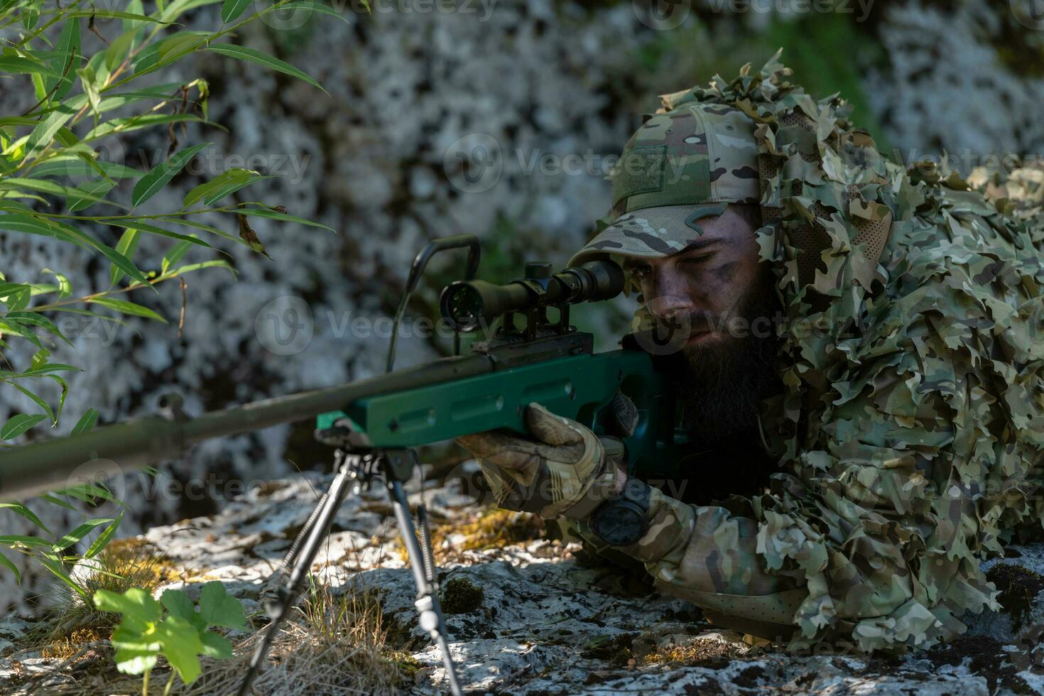 Army soldier holding sniper rifle with scope and aiming in forest. War, army, technology and people concept photo
