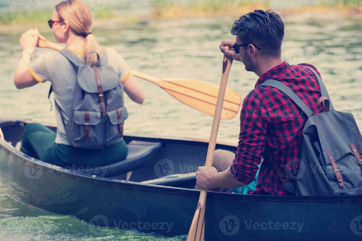 couple of explorers conoining on wild river photo