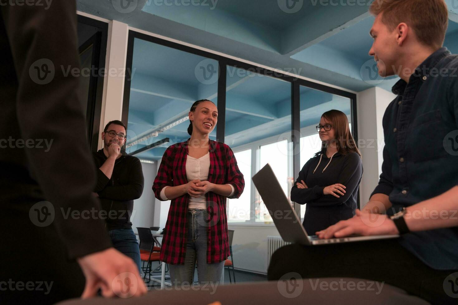 Top view photo of collaborative process of multicultural skilled young business team during brainstorming meeting in office.Diverse group of young people dressed in formal wear cooperating on developing design project