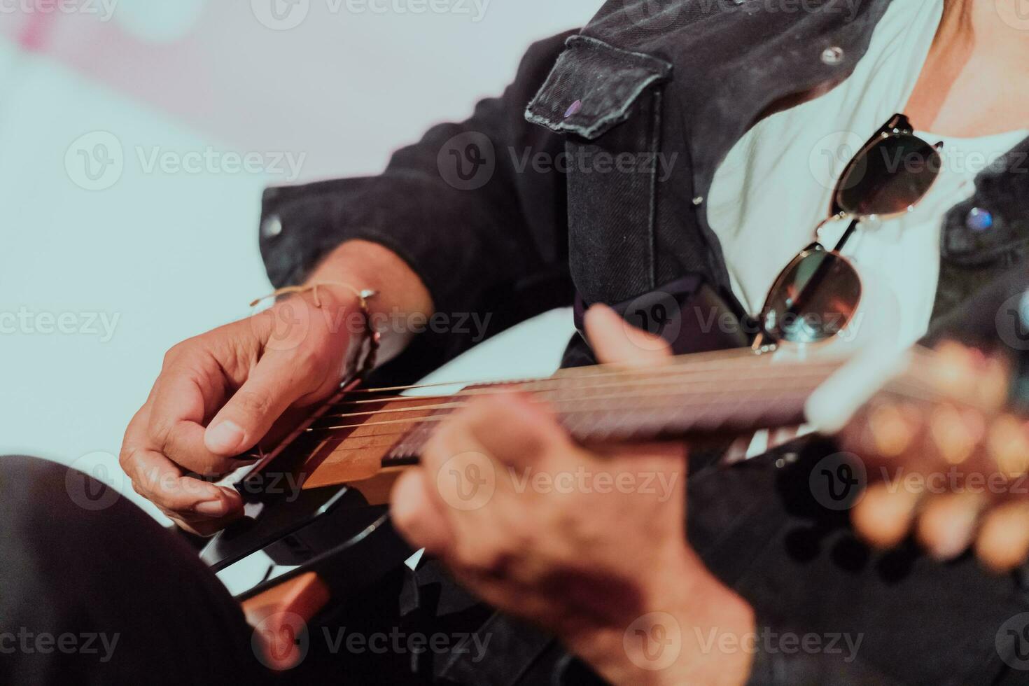 Practicing in playing guitar. Handsome young men playing guitar photo