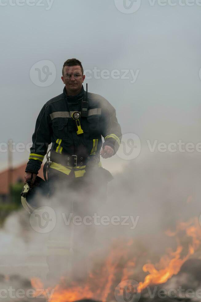 Portrait of a heroic fireman in a protective suit. Firefighter in fire fighting operation. photo