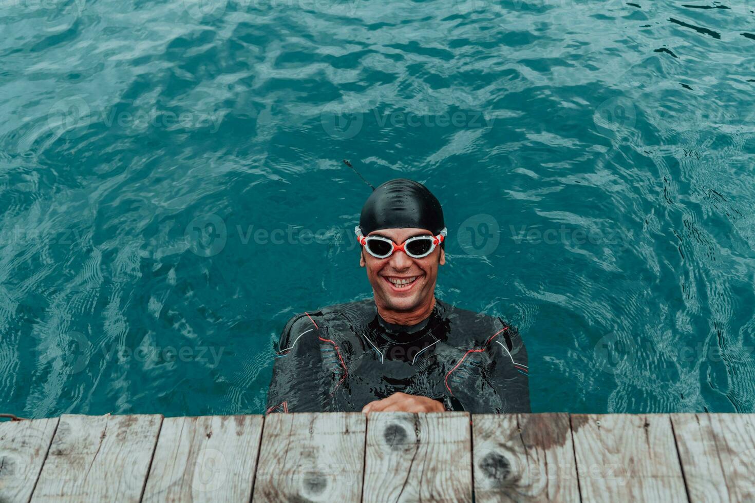 Triathlete swimmer portrait wearing wetsuit on training photo
