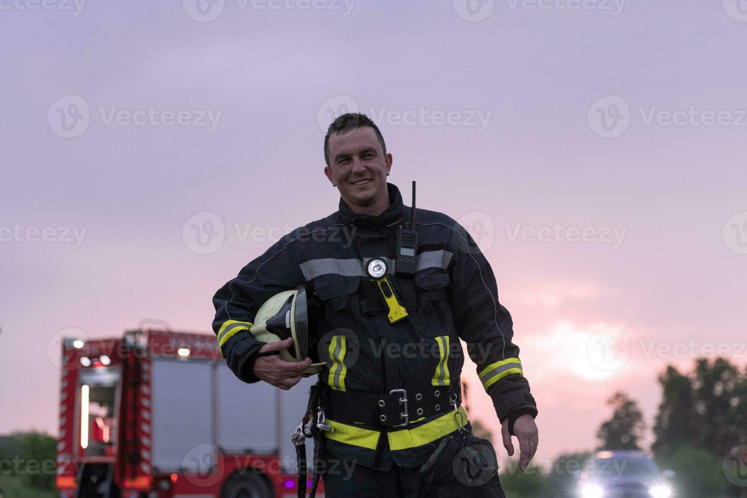 Portrait of a heroic fireman in a protective suit. Firefighter in fire fighting operation. photo