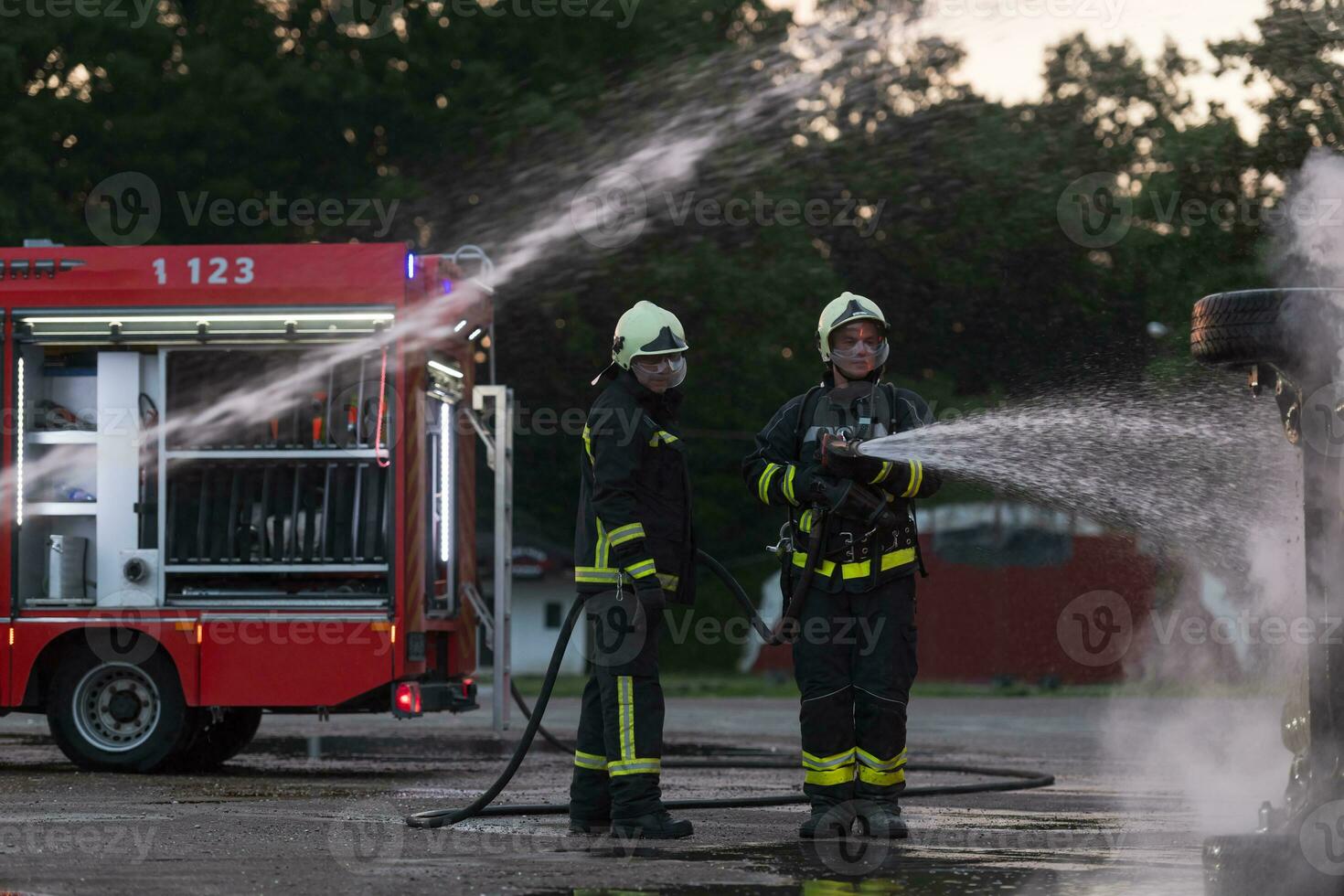 Firefighters fight the fire flame to control fire not to spreading out. Firefighter industrial and public safety concept. Traffic or car accident rescue and help action. photo