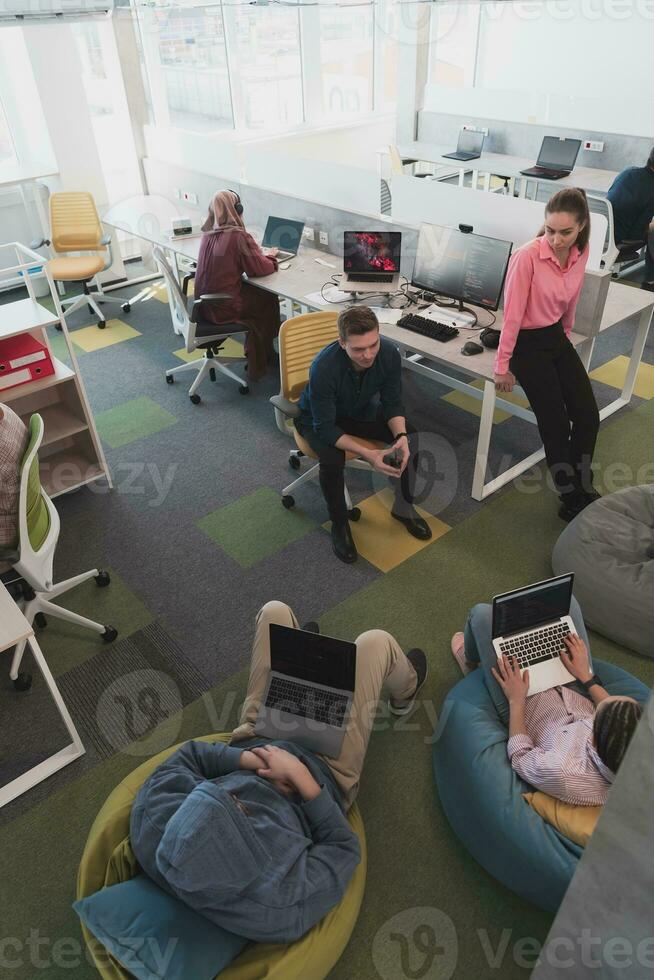 Top view photo of collaborative process of multicultural skilled young business team during brainstorming meeting in office.Diverse group of young people dressed in formal wear cooperating on developing design project