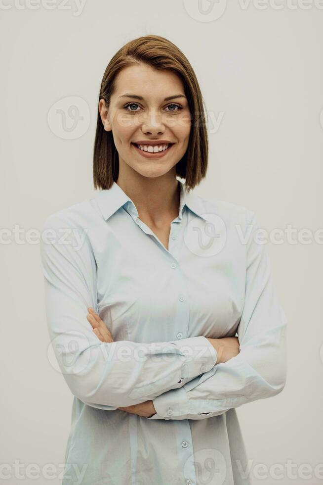 Portrait shot of a beautiful blond businesswoman standing with arms crossed at isolated white background. High quality photo