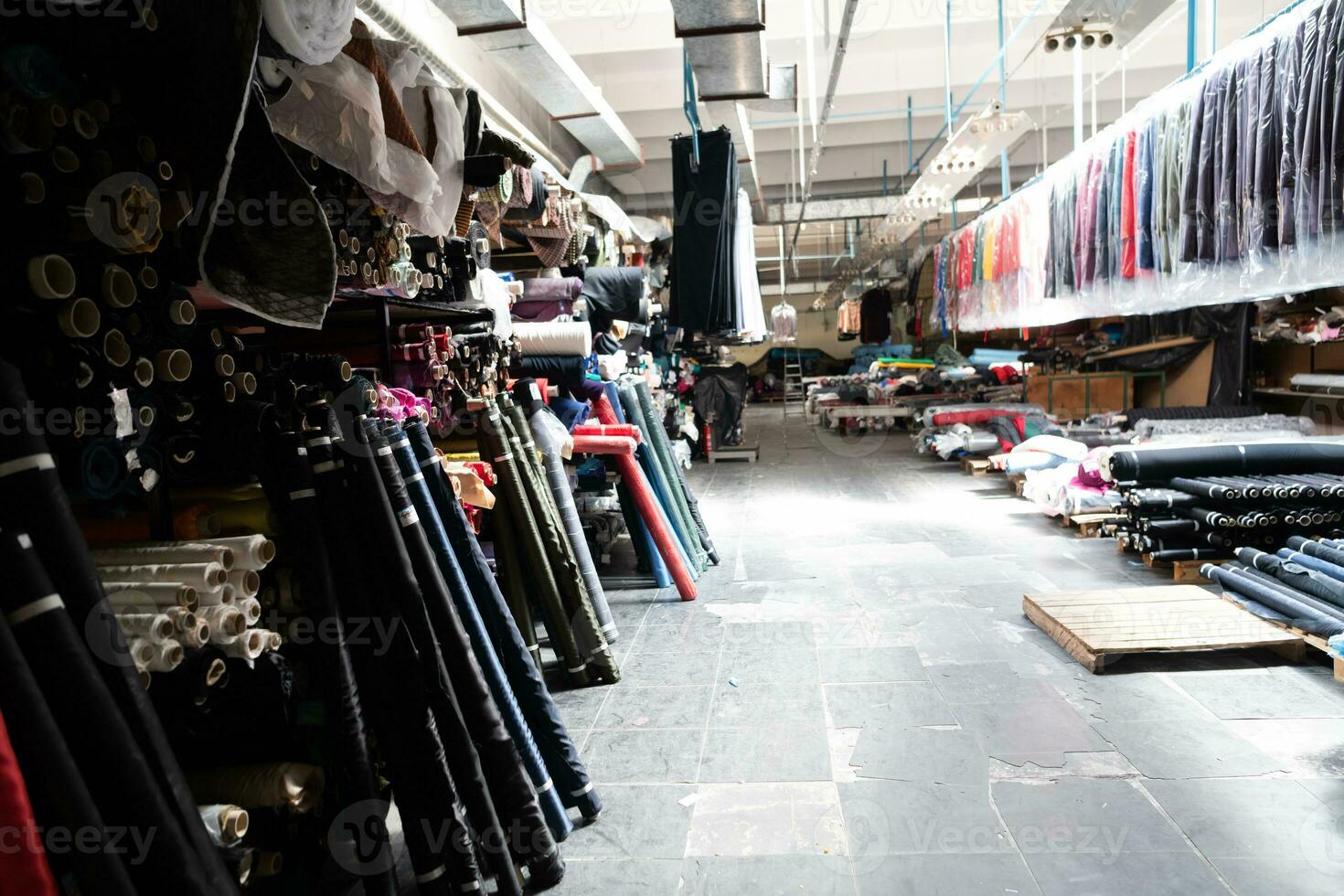 Interior of an industrial warehouse with fabric rolls samples. Small business textile colorful warehouse. photo