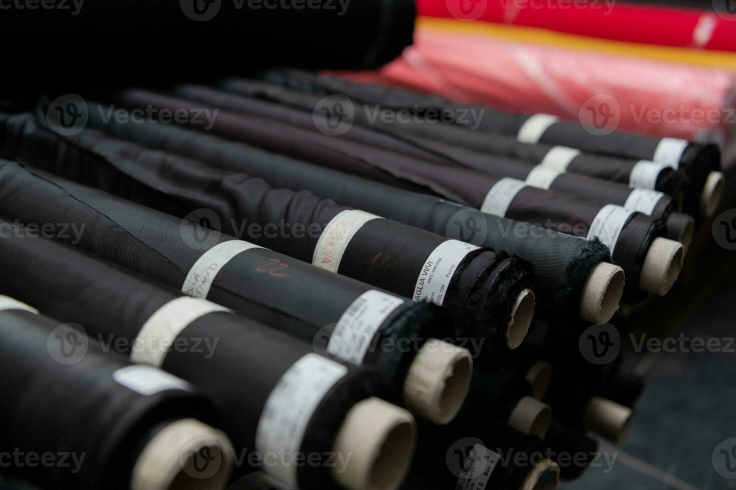 Interior of an industrial warehouse with fabric rolls samples. Small business textile colorful warehouse. photo