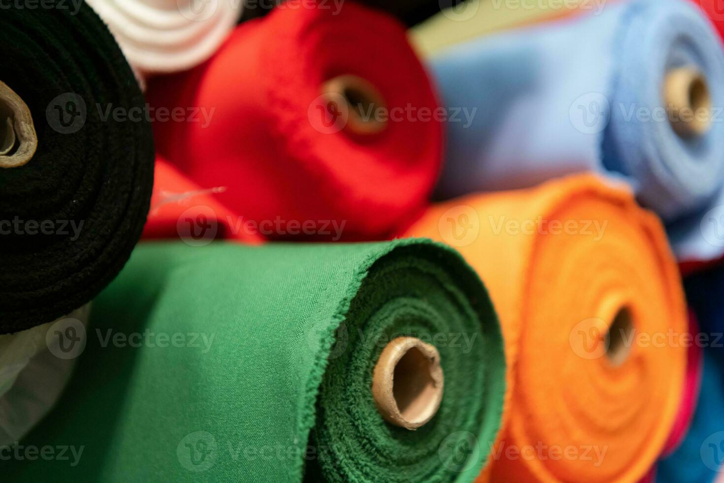 Collection of fashionable fabrics. Samples of different natural fabrics for sewing a fashion collection of clothes. Large selection of fabrics in the store or tailor warehouse. photo