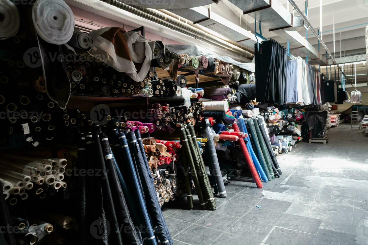 Interior of an industrial warehouse with fabric rolls samples. Small business textile colorful warehouse. photo